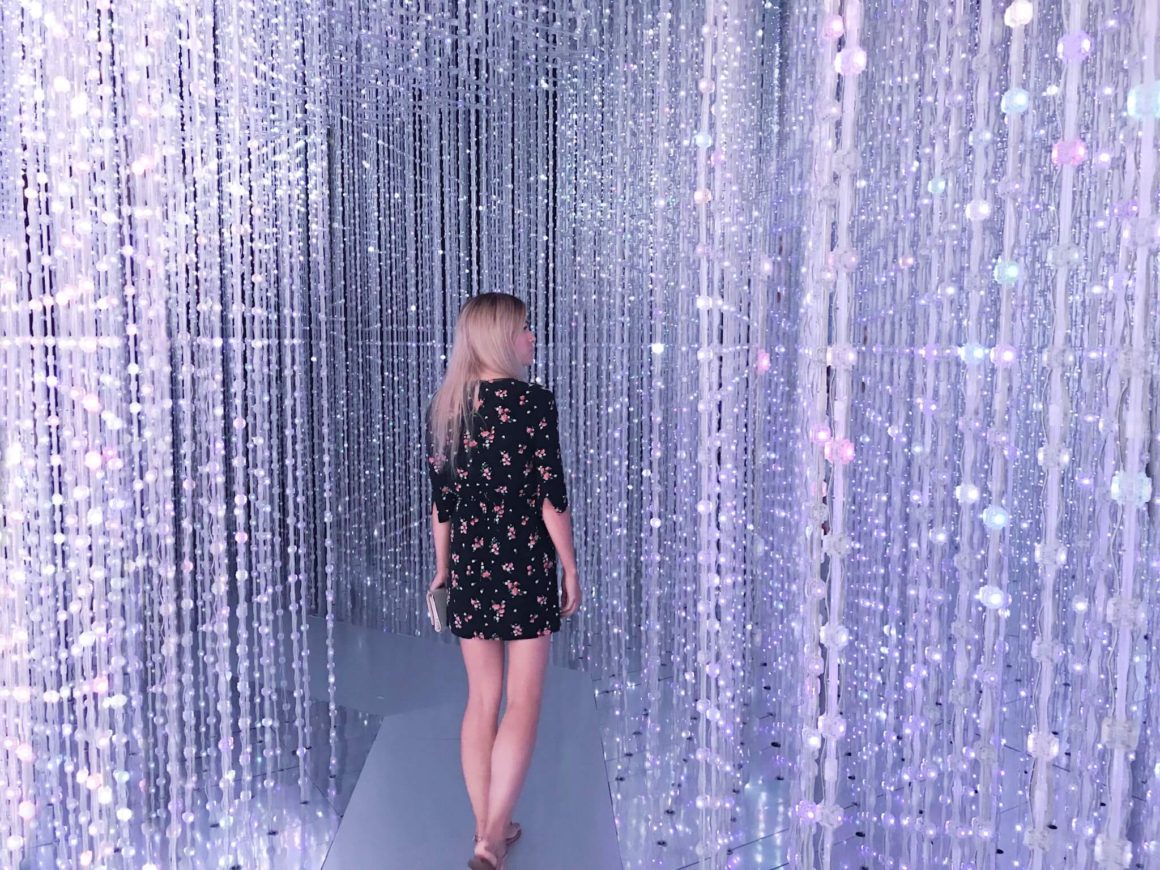 girl (Christina) walking through the Crystal Universe of stars at the Future World exhibit at the Art Science Museum in Singapore.