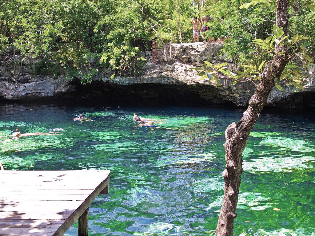 people swimming and snorkelling at Cenote Azul in Mexico