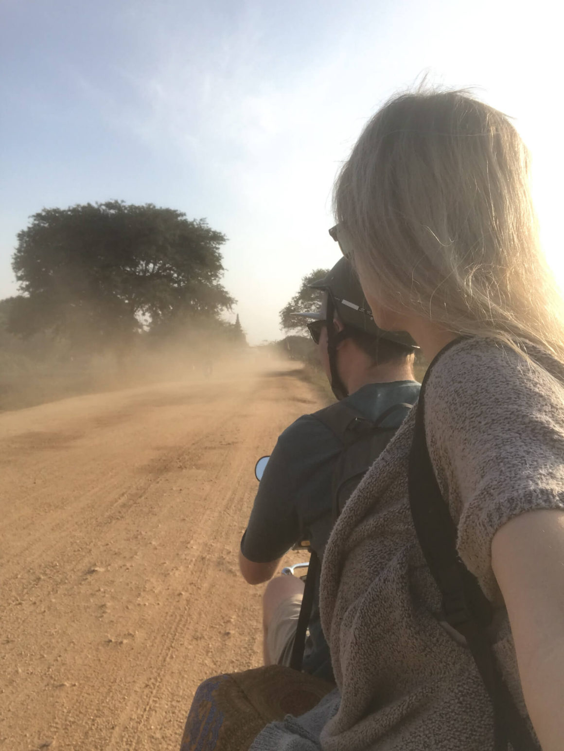 riding on the back of the e-bike in bagan, Myanmar down a dirt road
