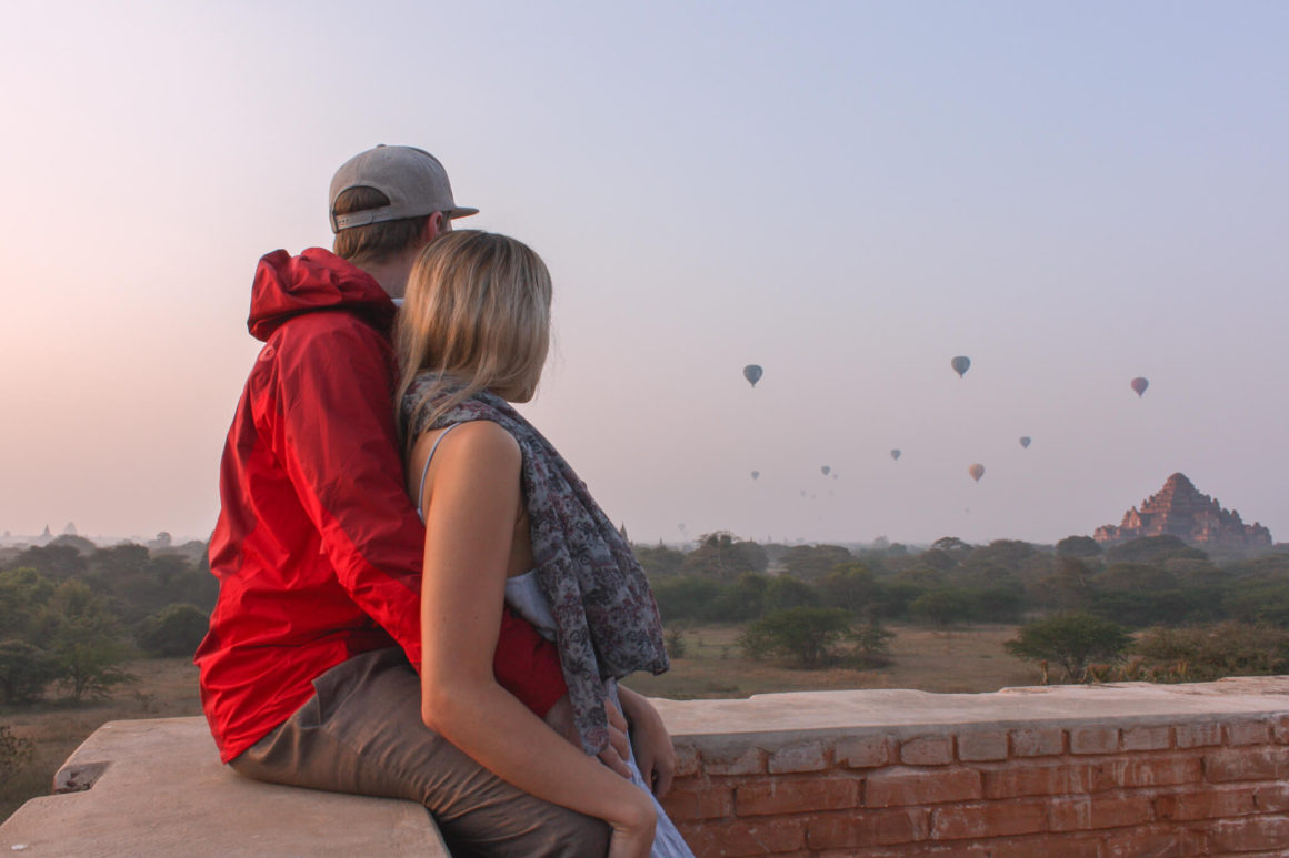 us watching hot air balloons rise in the morning sky at sunrise in bagan, Myanmar
